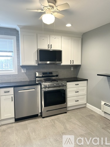 A kitchen with a stainless steel oven and microwave above it.