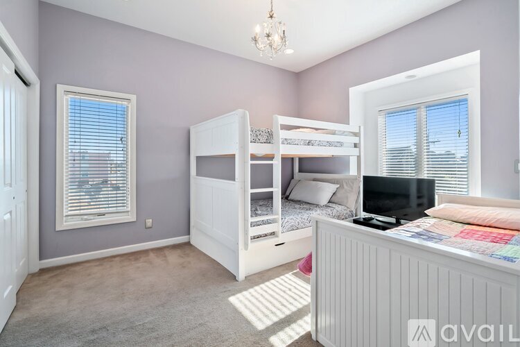 A bedroom with a bunk bed and a desk.