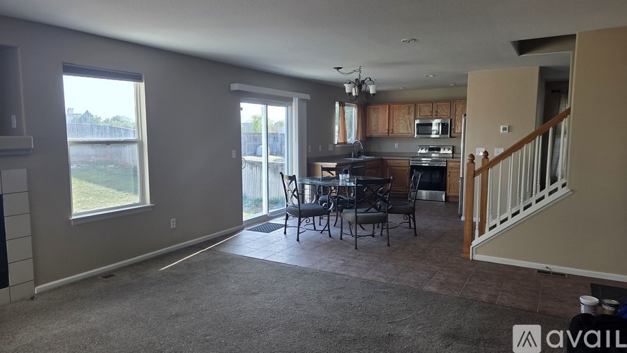 A living room with a dining table and chairs is available for rent.