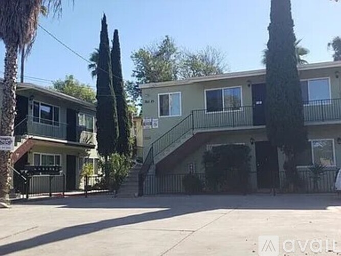 A two-story house with a balcony on the second floor.
