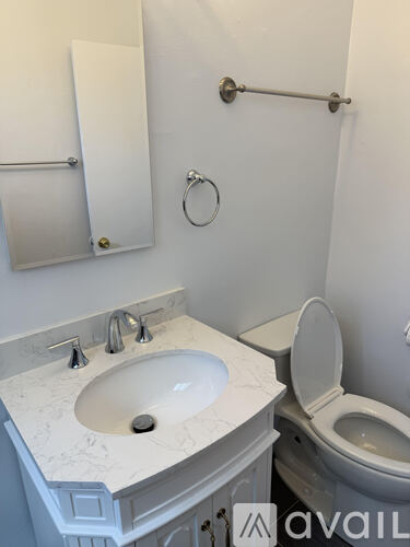 A bathroom with a toilet and a sink.