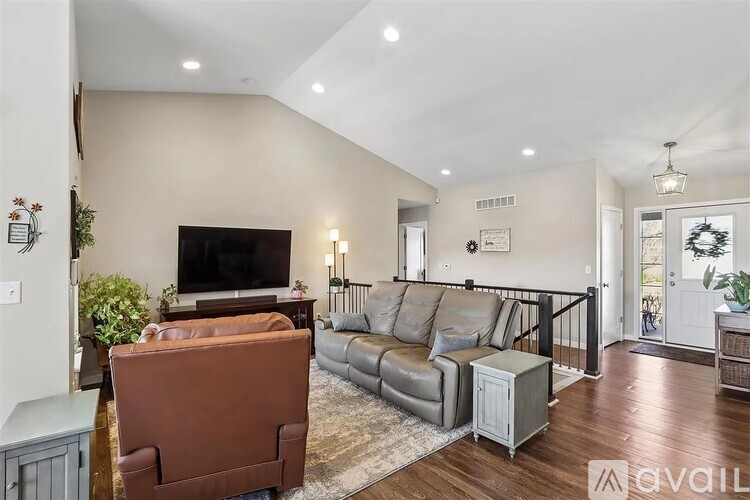 A living room with a brown sofa and a television.