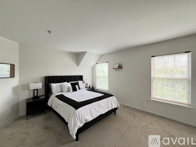A bedroom with a large bed and a window.