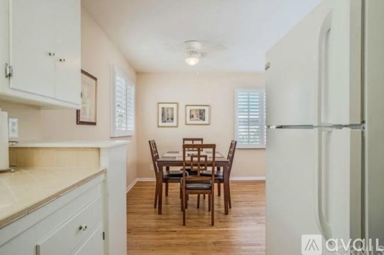 A kitchen with a table and chairs in the middle of it.