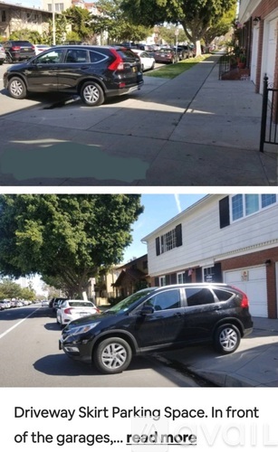 A black car is parked in a driveway skirt parking space.