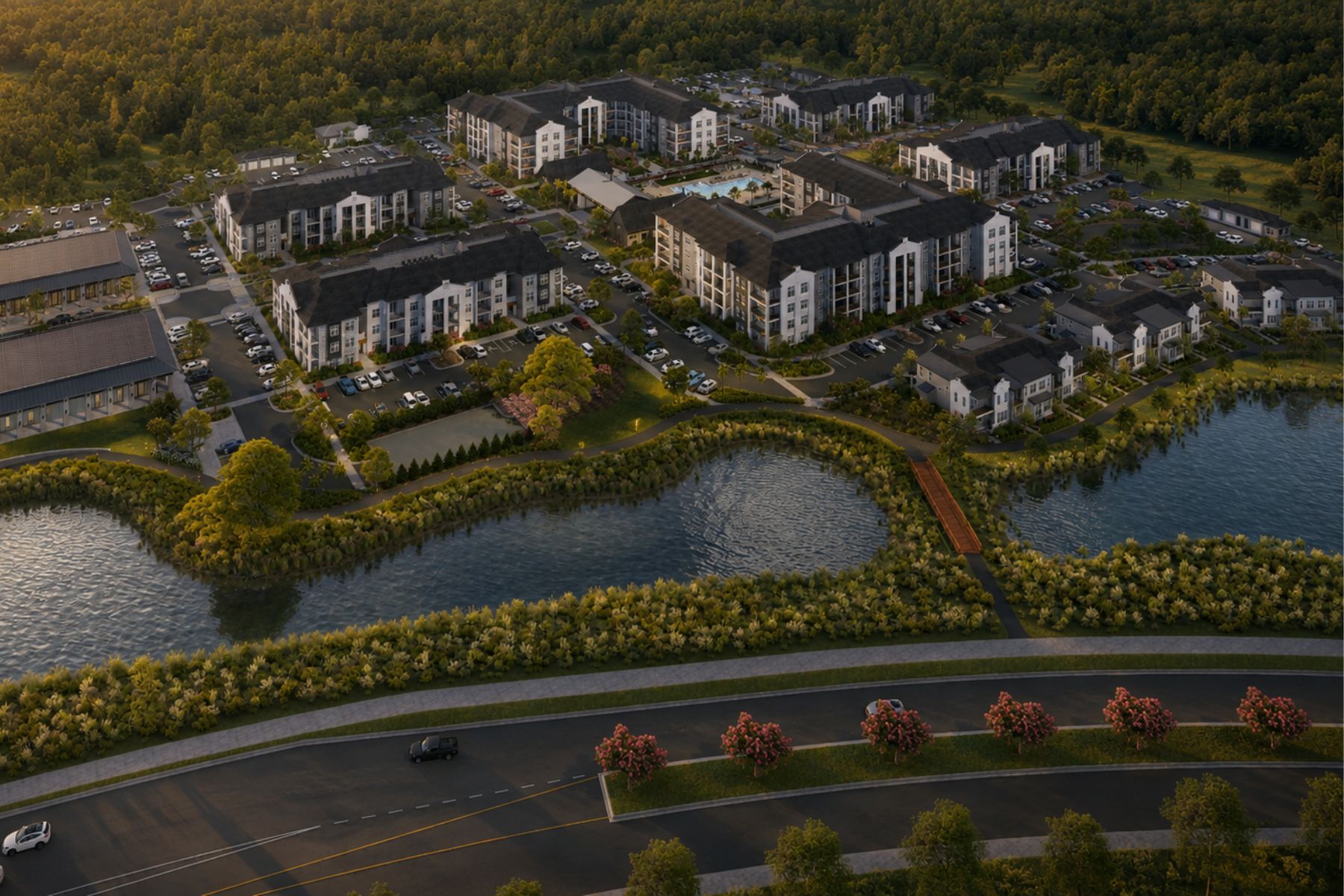 A large building complex with a lake in front.
