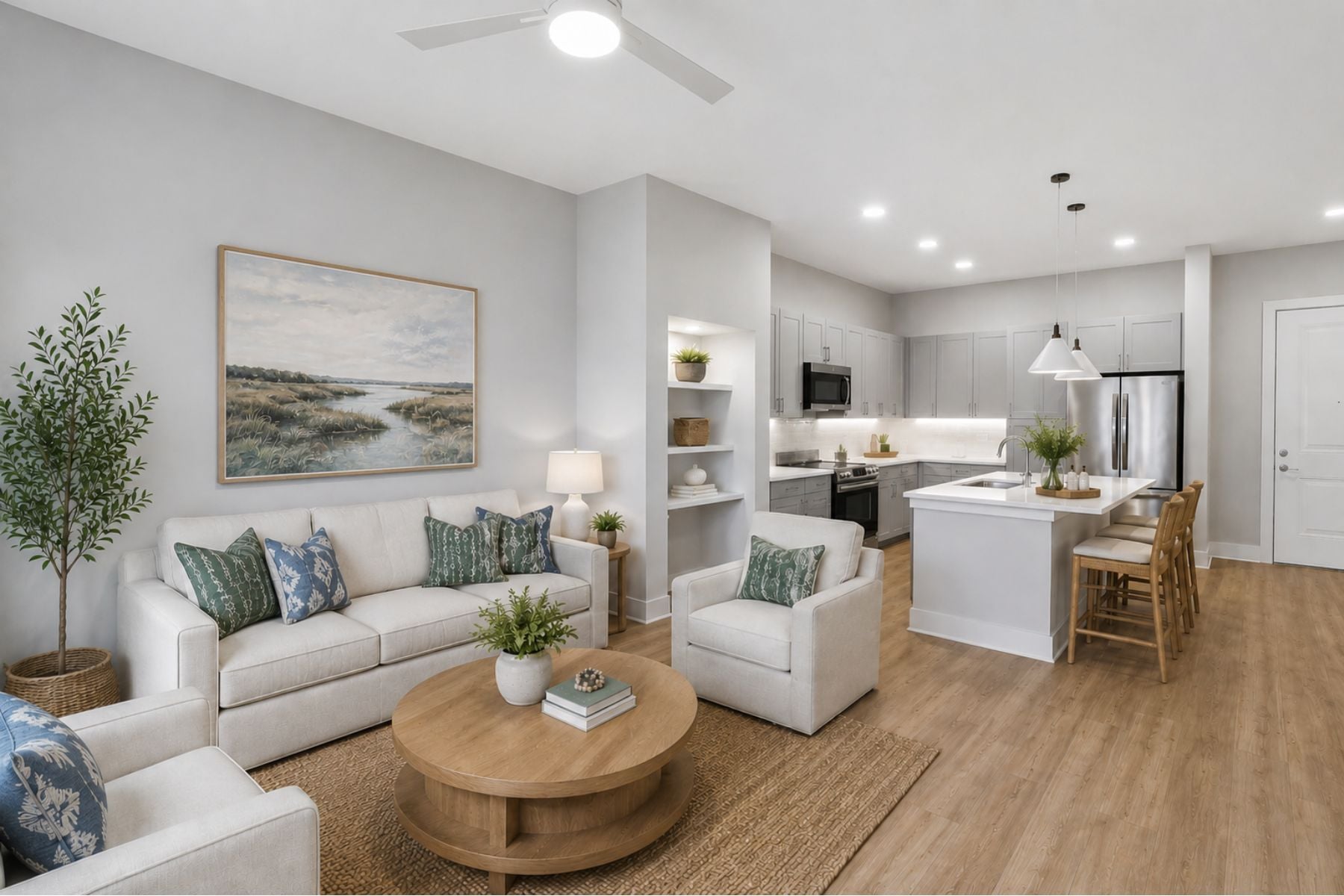 A living room with a white couch, a coffee table, and a painting on the wall.