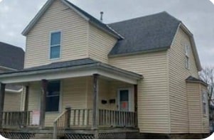 A house with a porch and a small front yard.