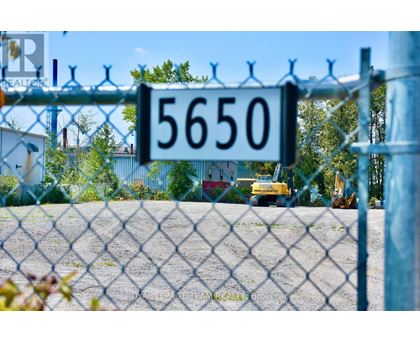 A chain link fence with a sign that reads 5650.