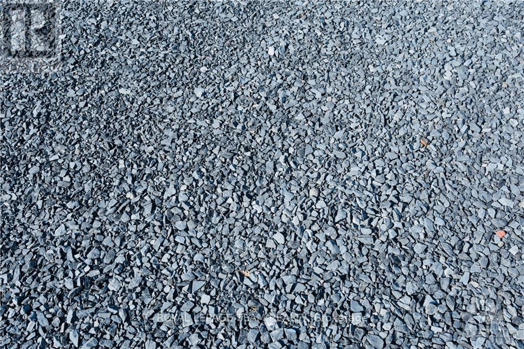 A close up of a textured surface with a small orange object in the middle.