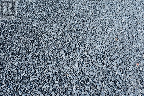 A close up of a textured surface with a small orange object in the middle.