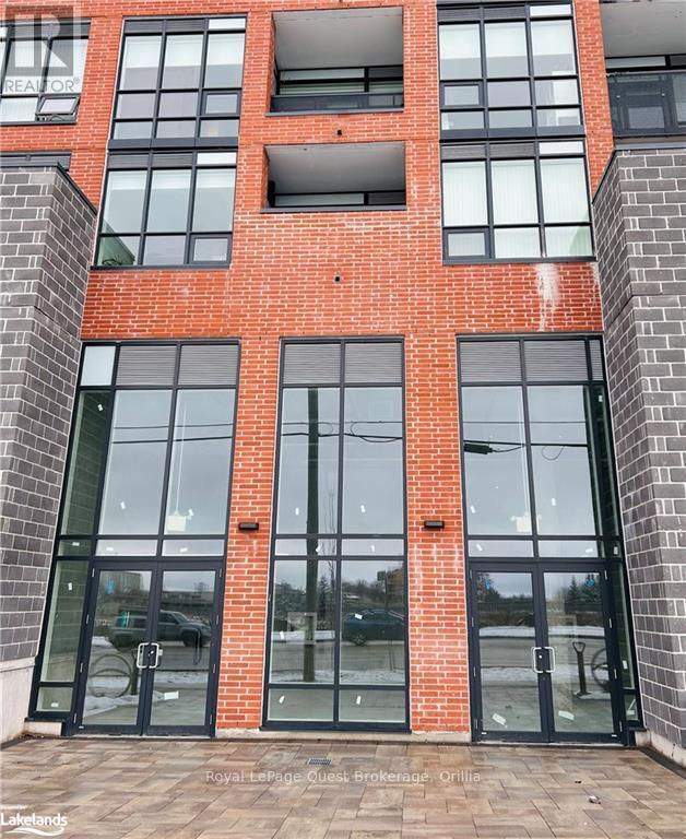 A red brick building with a glass door and windows.