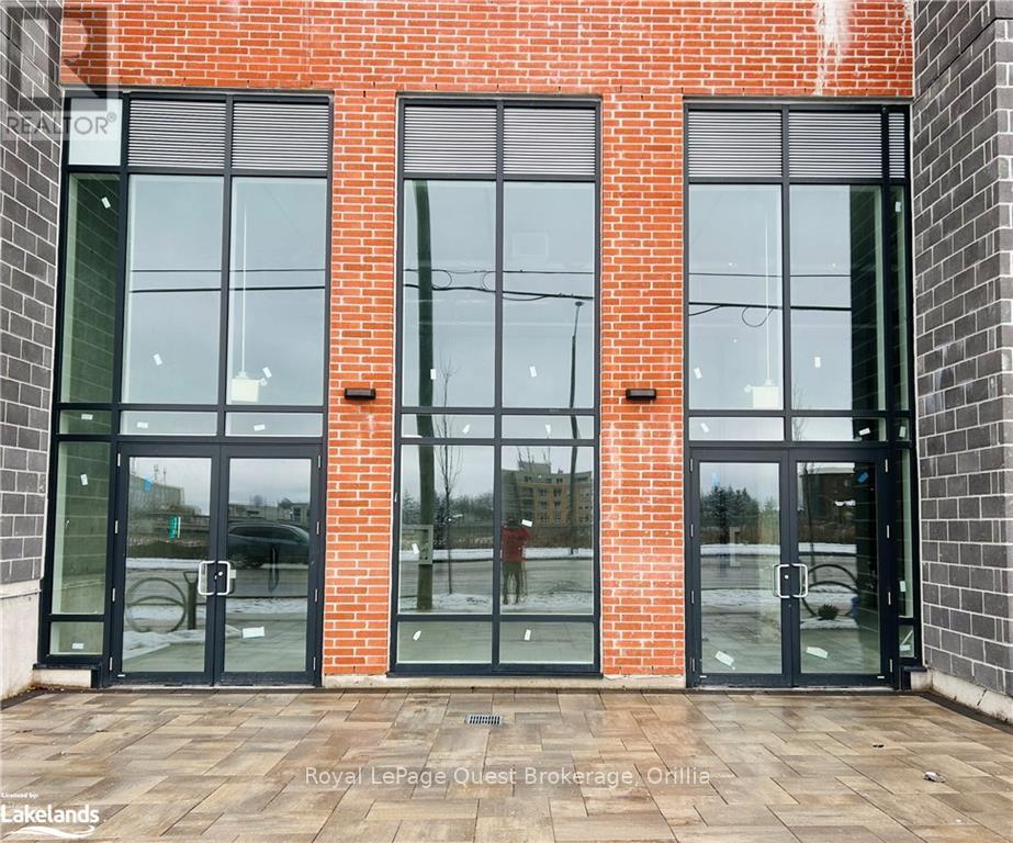 A building with a red brick wall and black doors.
