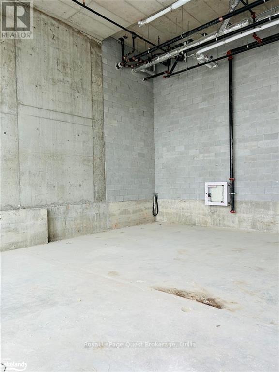 A large empty room with concrete walls and floor.