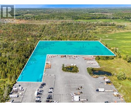 A large swimming pool is surrounded by a parking lot.