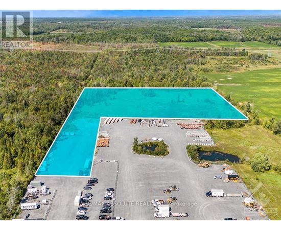 A large swimming pool is surrounded by a parking lot.
