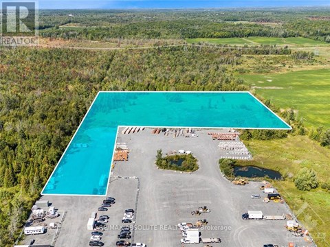 A large swimming pool is surrounded by a parking lot.