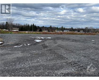 A parking lot with a REALTOR sign in the corner.
