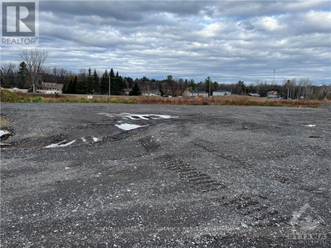 A parking lot with a REALTOR sign in the corner.