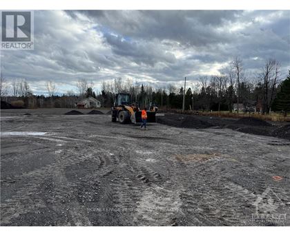 A construction site with a bulldozer and a person standing nearby.