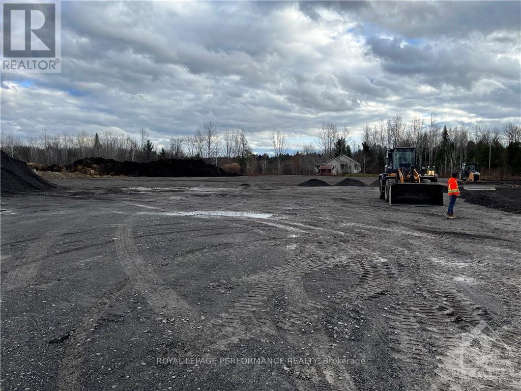 A construction site with a person standing near a bulldozer.