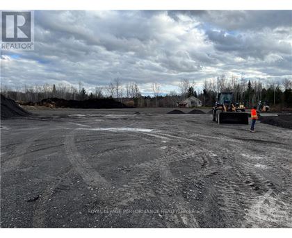 A construction site with a person standing near a bulldozer.