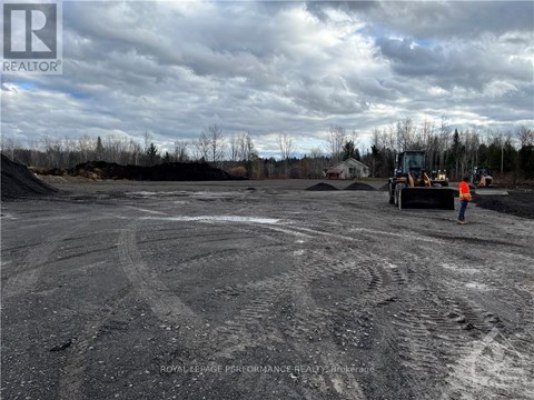 A construction site with a person standing near a bulldozer.