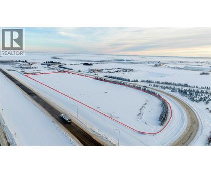 A car is driving on a snowy road with a red line on the side.