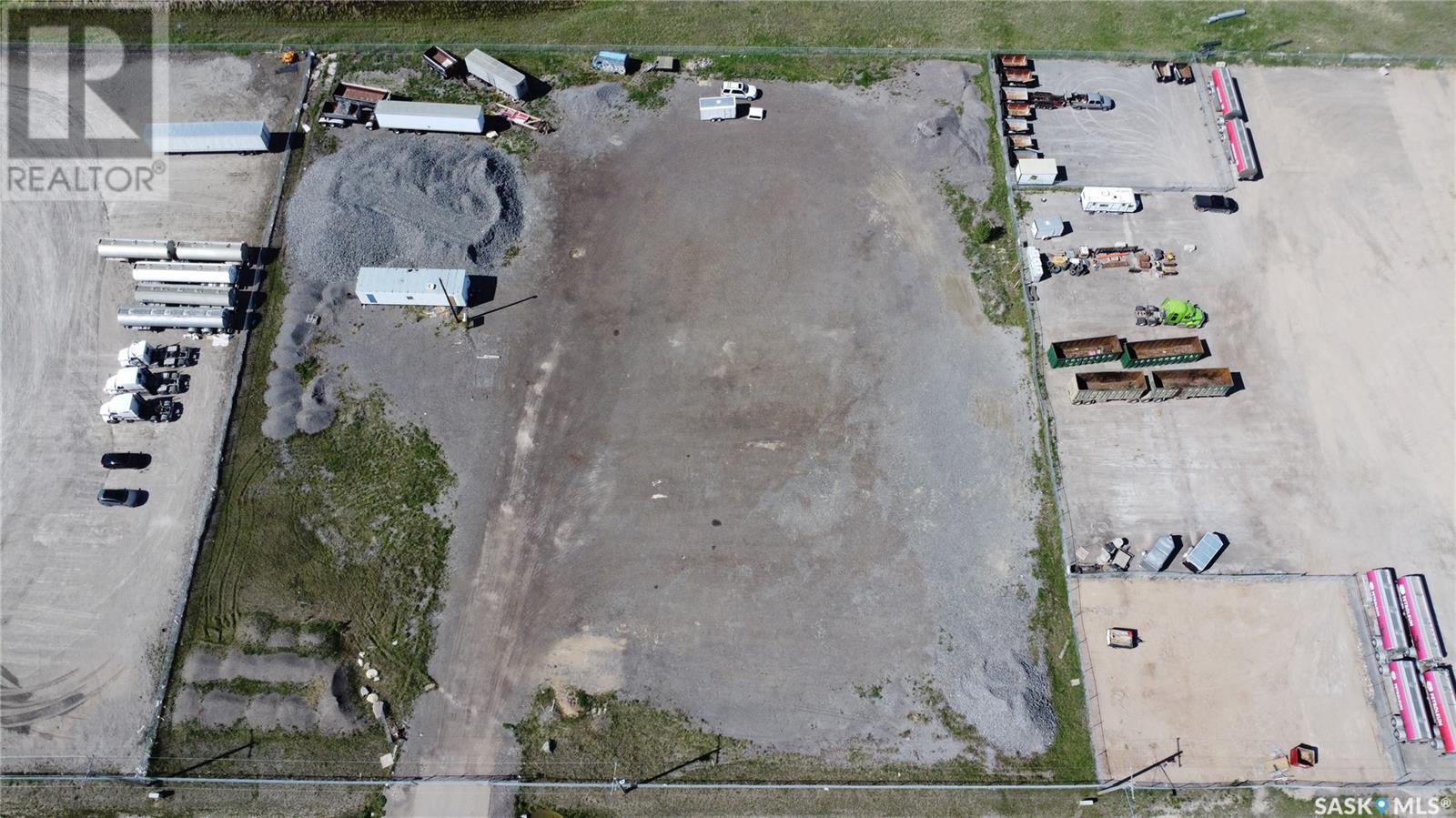 An aerial view of a construction site with a large open area and various vehicles and equipment.