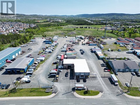 A large industrial area with multiple buildings and vehicles.