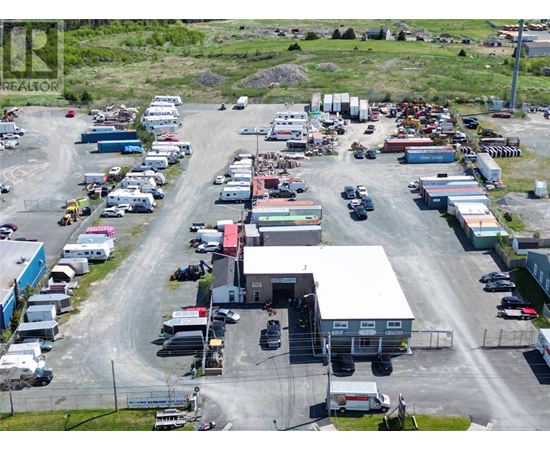 A large industrial area with multiple buildings and vehicles.