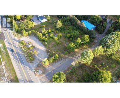 A bird's eye view of a road with a blue pool and a white building.
