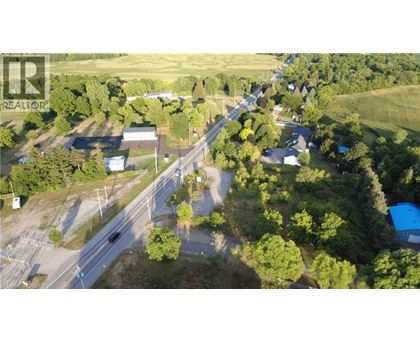 A bird's eye view of a small town with a main road running through it.