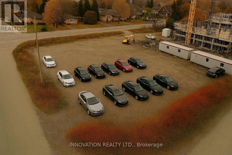 A parking lot with cars and a building in the background.