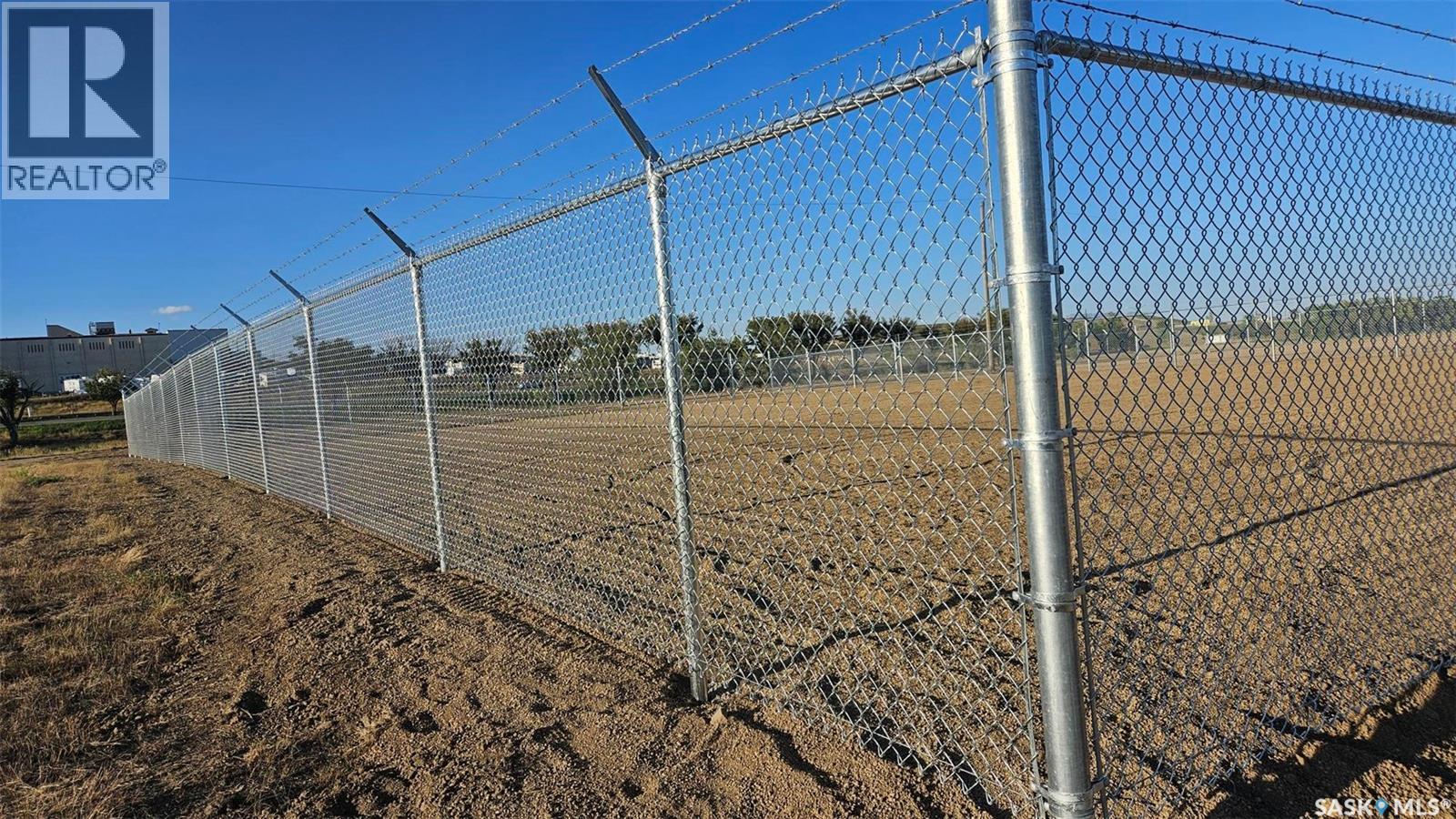 A chain link fence stretches across a field.