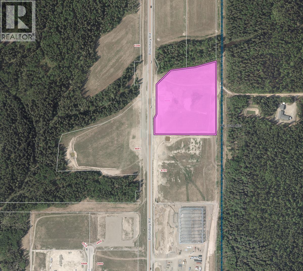 A satellite image of a property with a pink highlighted area.
