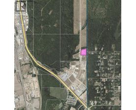 A satellite image shows a road passing through a residential area.
