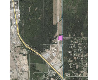 A satellite image shows a road passing through a residential area.