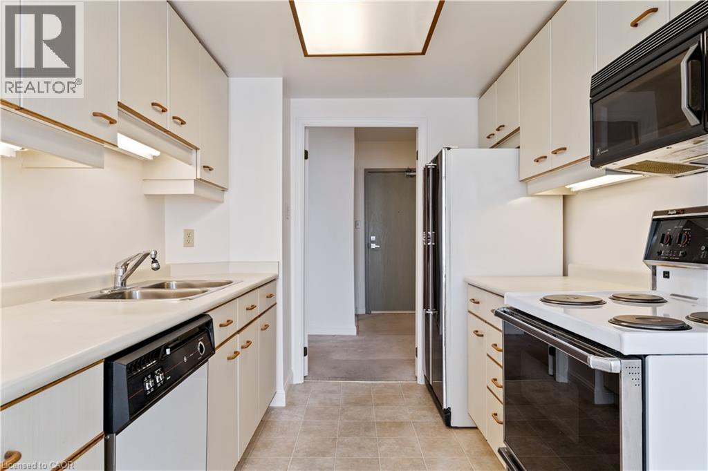 A kitchen with white cabinets and appliances.