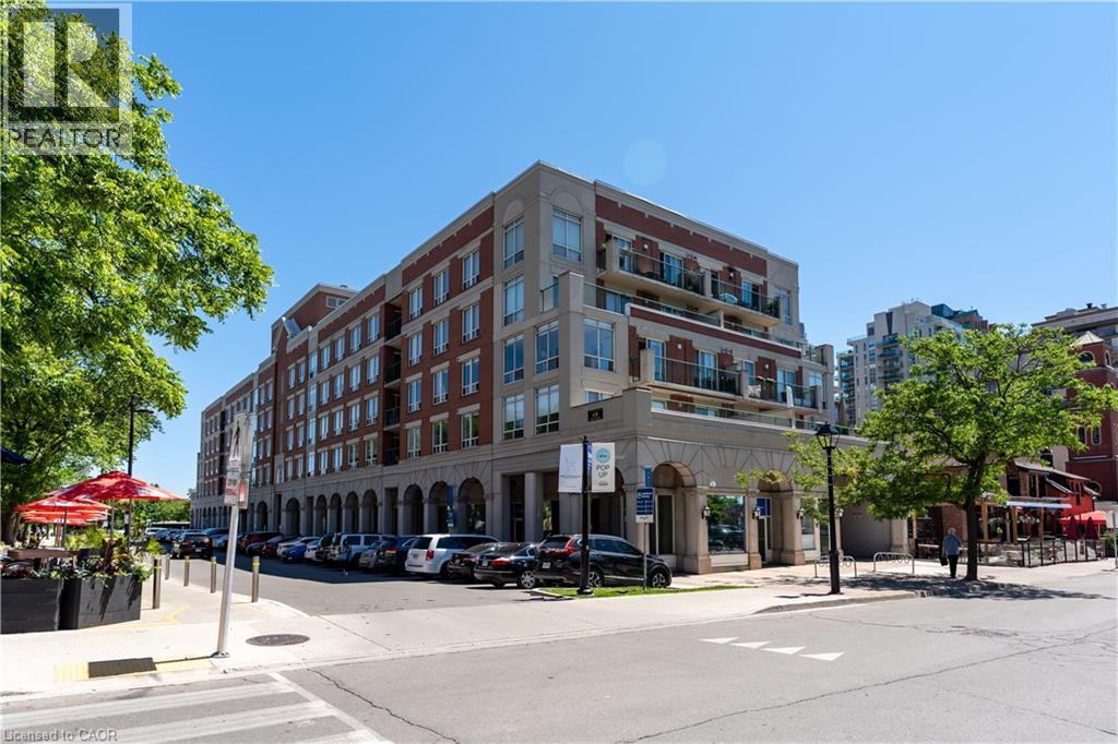 A street view of a multi-story building with a clear blue sky above.