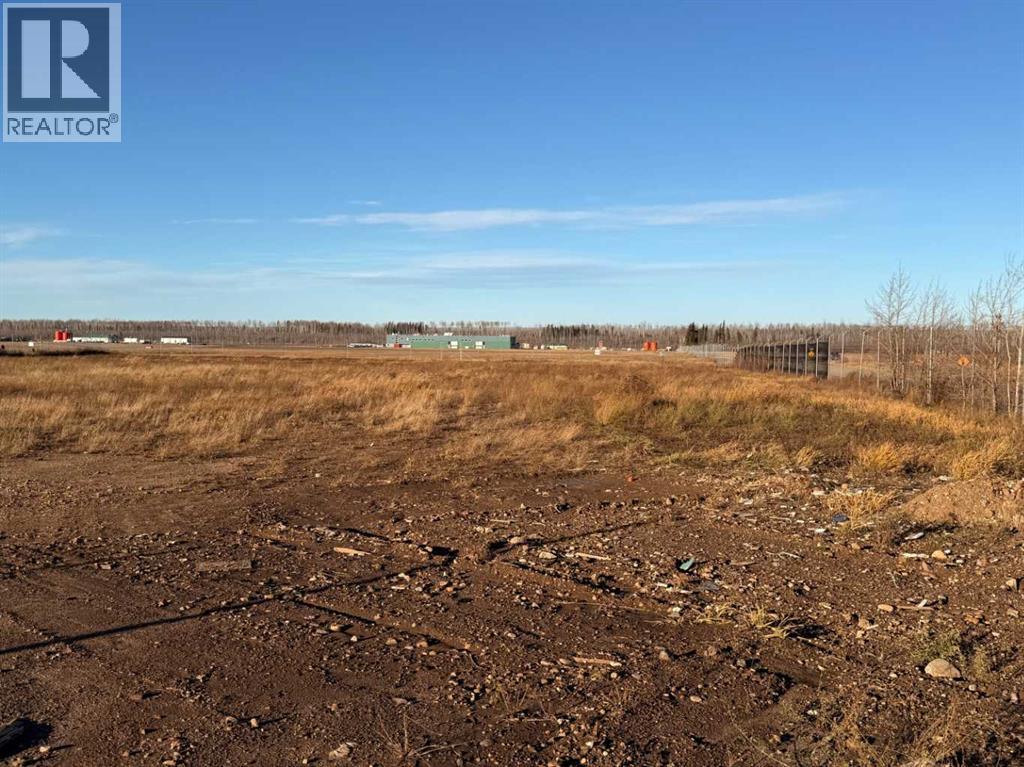 A barren field with a REALTOR® logo in the corner.
