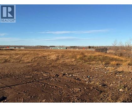 A barren field with a REALTOR® logo in the corner.