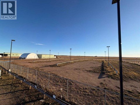 A fenced area with a sign that says REALTOR.