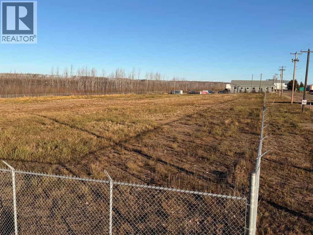 A fenced field with a REALTOR® logo in the corner.