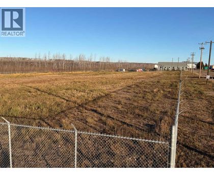 A fenced field with a REALTOR® logo in the corner.