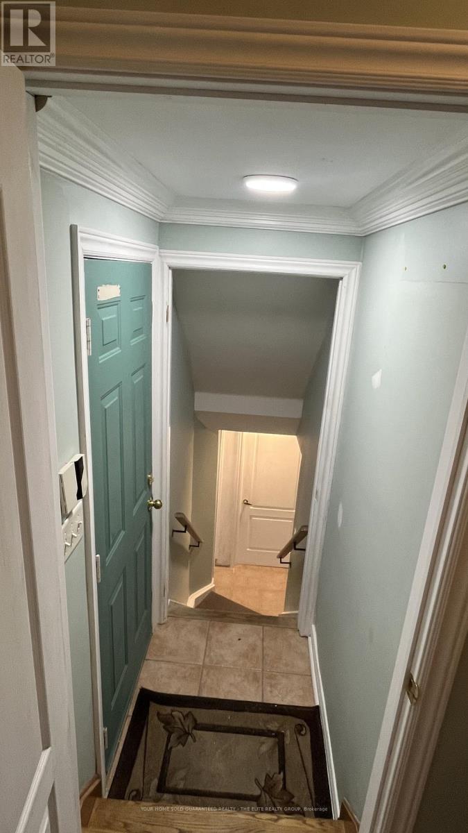 A hallway with a blue door and a staircase.