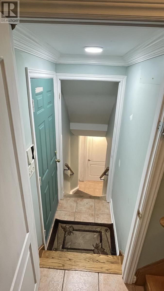 A hallway with a blue door and a light on the ceiling.