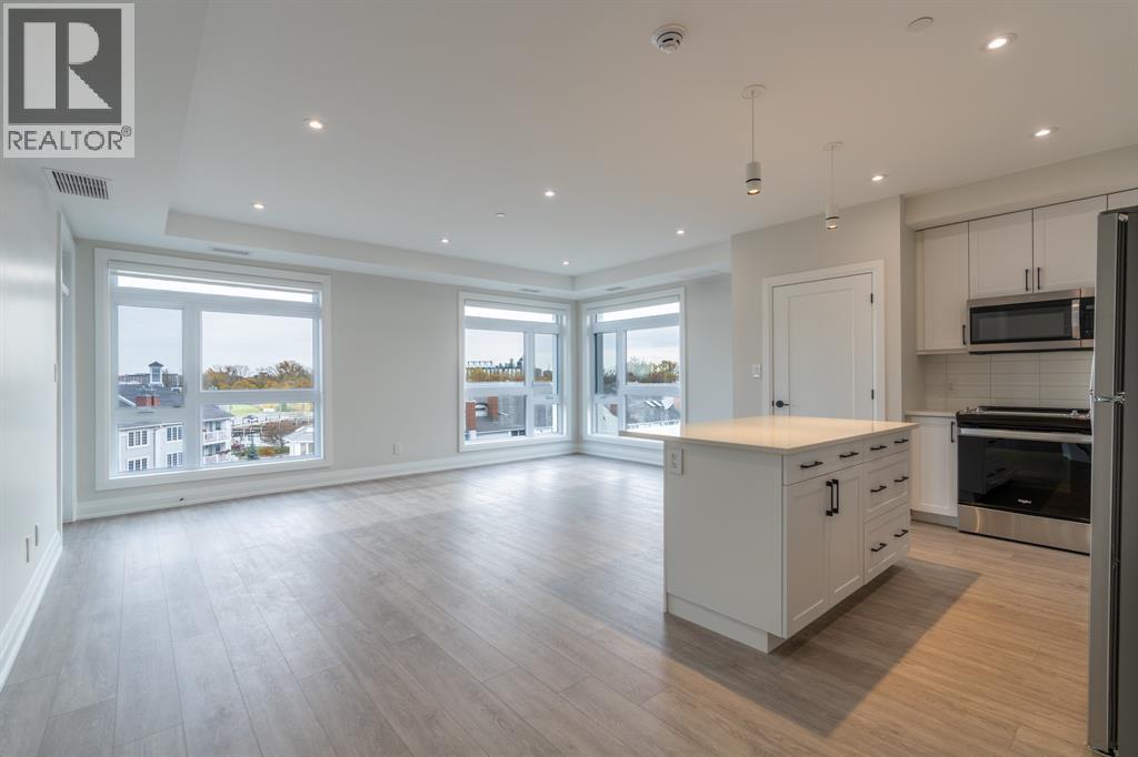A spacious kitchen with white cabinets and a large island.