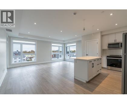 A spacious kitchen with white cabinets and a large island.