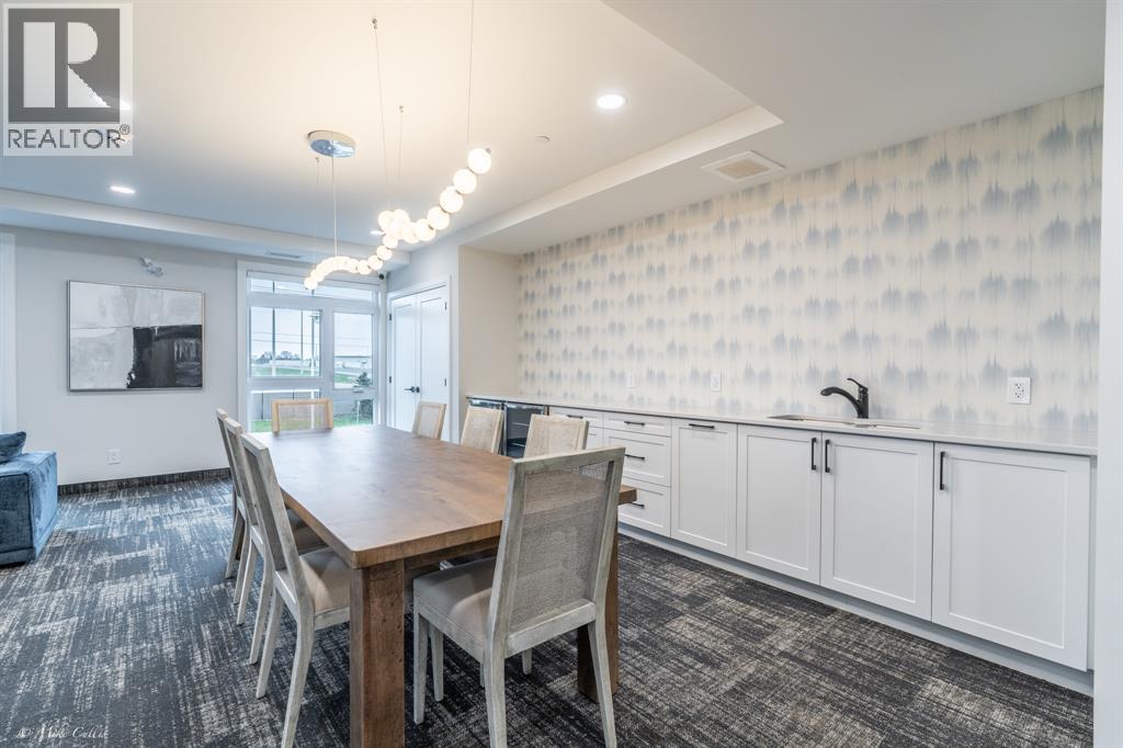 A dining room with a wooden table and chairs.